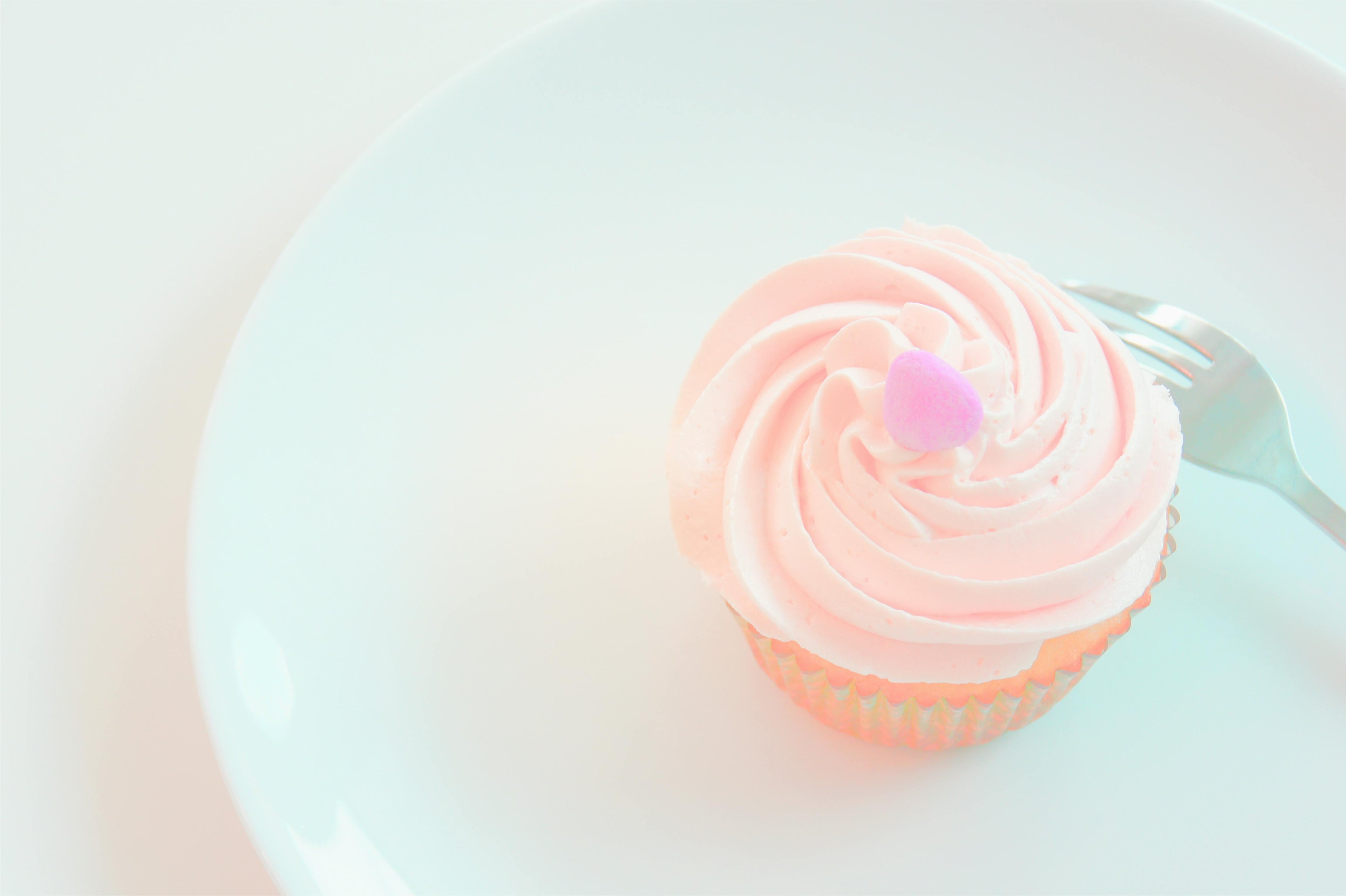 Pink pastel cupcake plated with a fork
